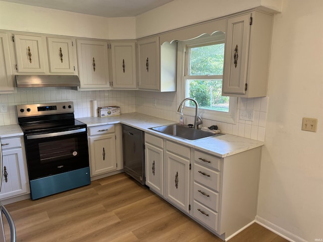 kitchen with light wood-type flooring, appliances with stainless steel finishes, backsplash, and sink