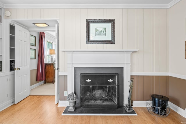 room details featuring crown molding, wood walls, and hardwood / wood-style floors