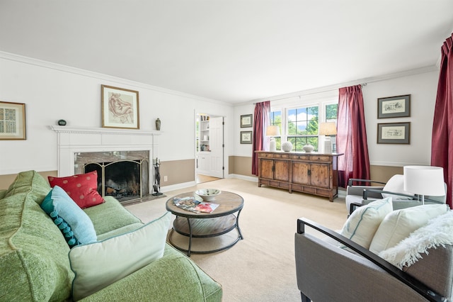 living room with a high end fireplace, ornamental molding, and carpet