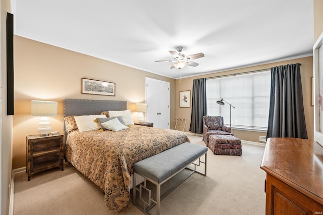 carpeted bedroom featuring crown molding and ceiling fan