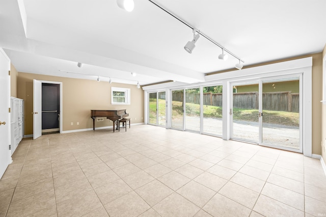 unfurnished sunroom featuring rail lighting