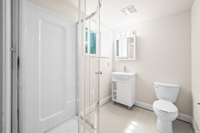 bathroom featuring vanity, toilet, and a shower