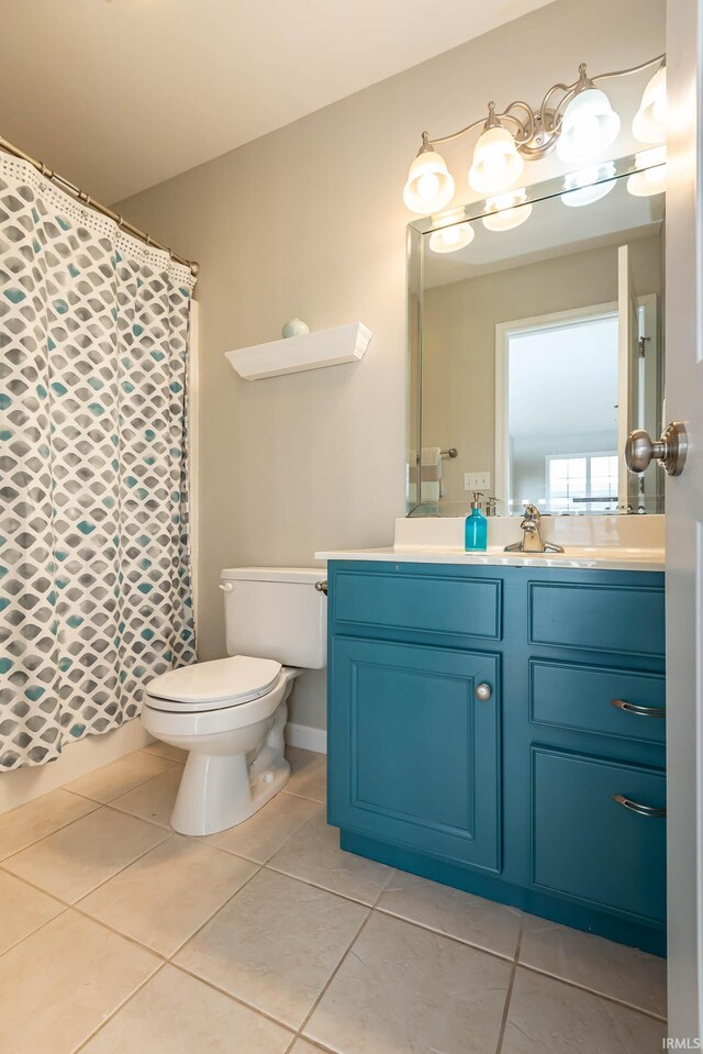 bathroom featuring tile patterned flooring, vanity, and toilet