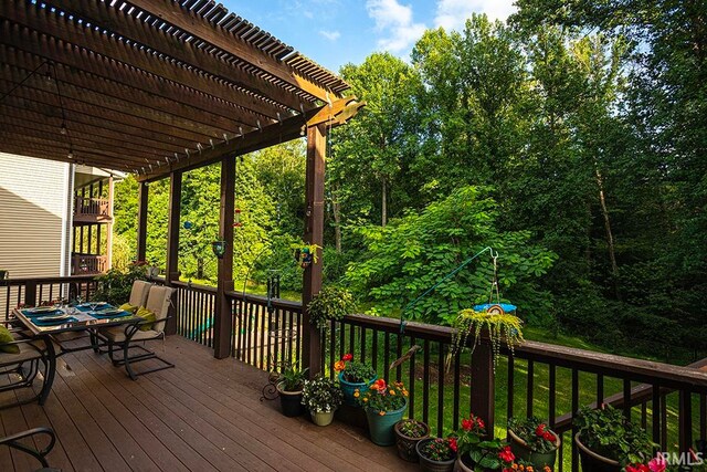 wooden deck featuring a pergola