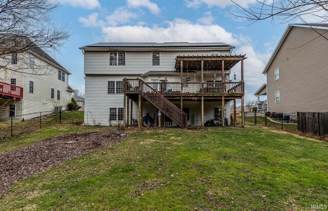 back of house with a wooden deck, a yard, and a pergola