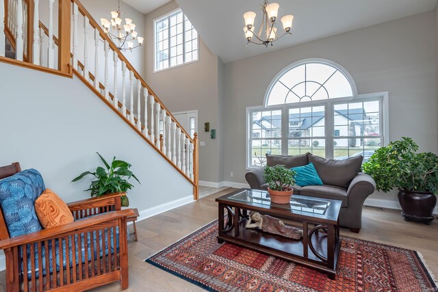 living room featuring hardwood / wood-style floors, an inviting chandelier, and a healthy amount of sunlight