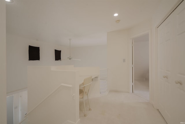 corridor with baseboards, light colored carpet, and recessed lighting