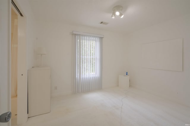 interior space with baseboards, carpet flooring, and visible vents