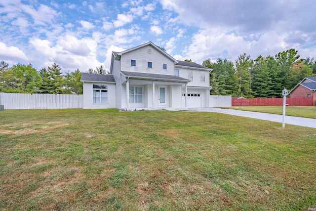 view of front of home featuring driveway, a garage, fence, and a front yard