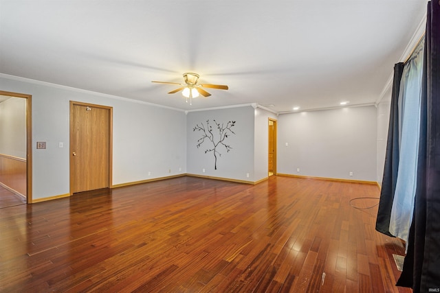 spare room featuring ceiling fan, dark hardwood / wood-style floors, and crown molding