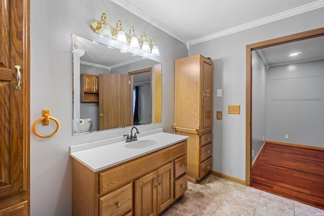 bathroom with wood-type flooring, vanity, and ornamental molding