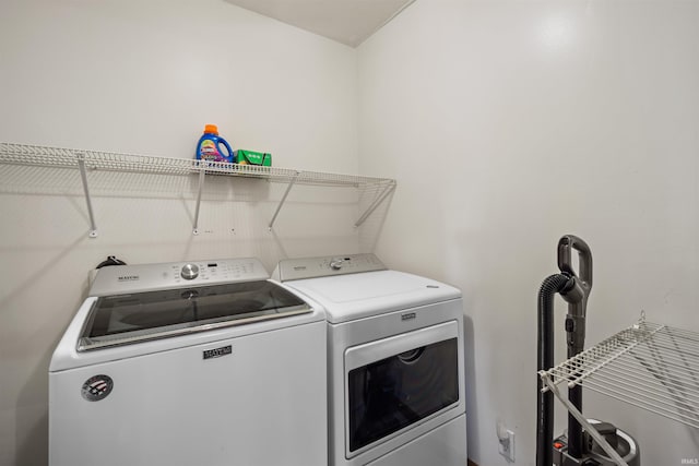 clothes washing area with washing machine and dryer