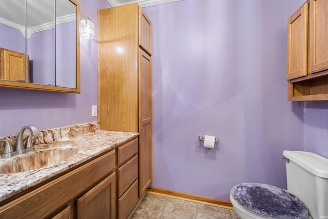 bathroom featuring tile patterned floors, vanity, toilet, and ornamental molding