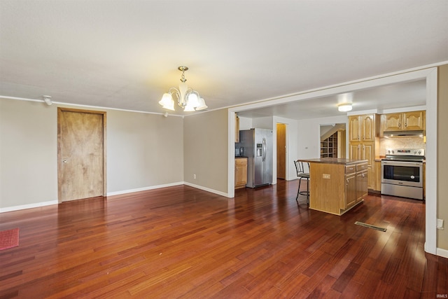 unfurnished living room with an inviting chandelier and dark hardwood / wood-style flooring