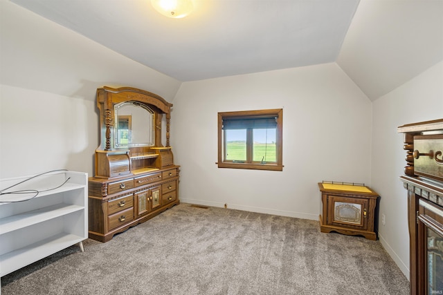 carpeted bedroom with vaulted ceiling