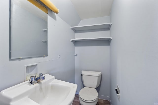 bathroom with toilet, wood-type flooring, and sink