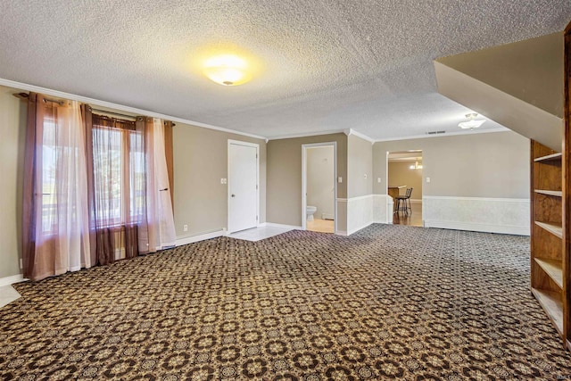 bonus room with a textured ceiling, carpet flooring, and a baseboard heating unit