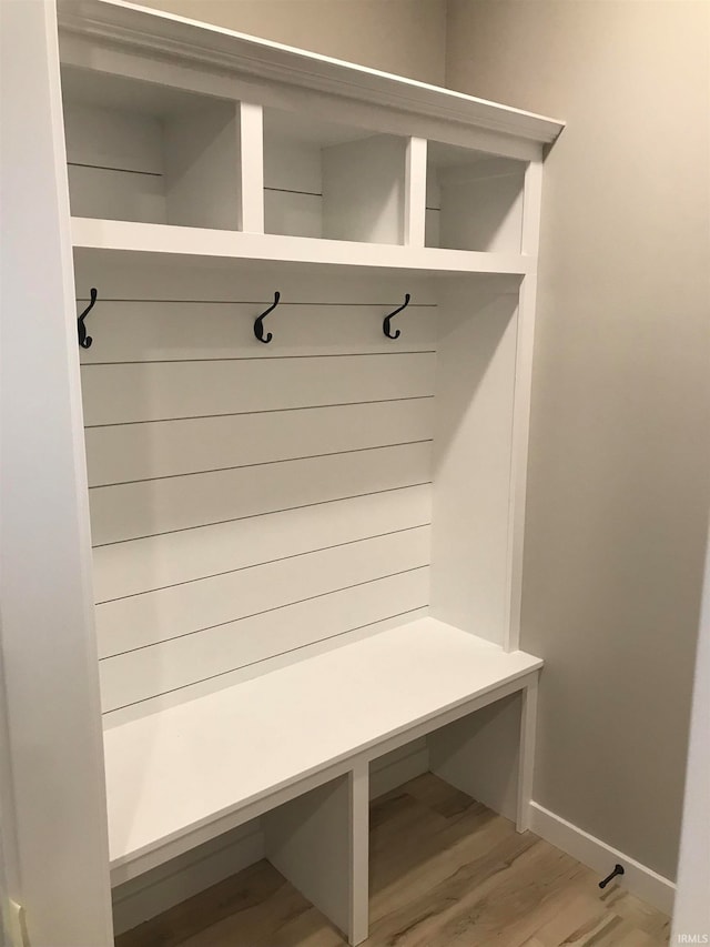 mudroom with light wood-type flooring and baseboards