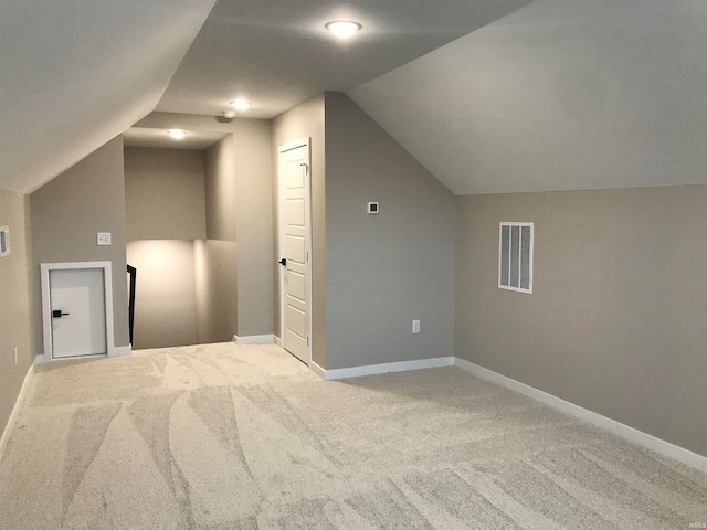 additional living space with lofted ceiling, carpet, visible vents, and baseboards