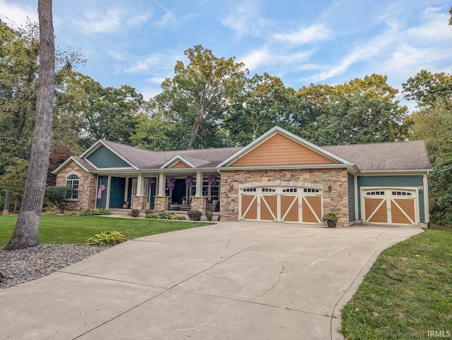 craftsman house featuring a garage and a front yard