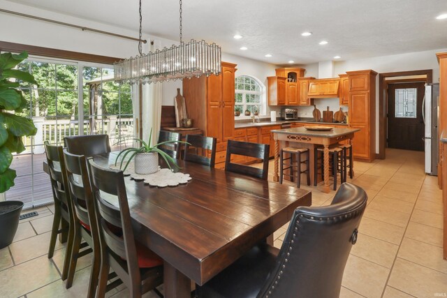 tiled dining room featuring sink