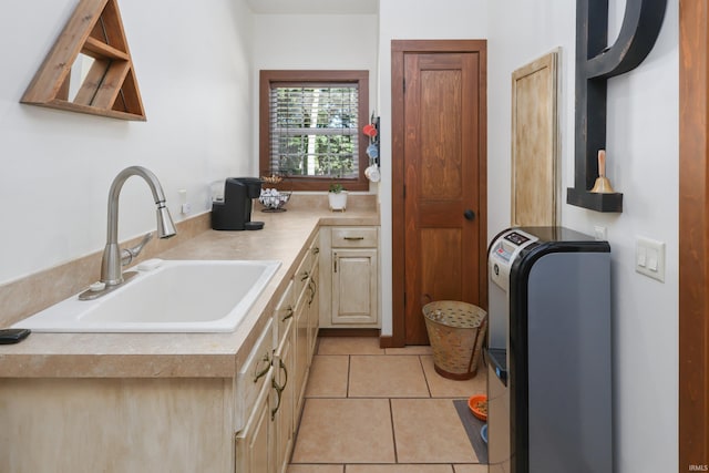 kitchen featuring light tile patterned floors and sink