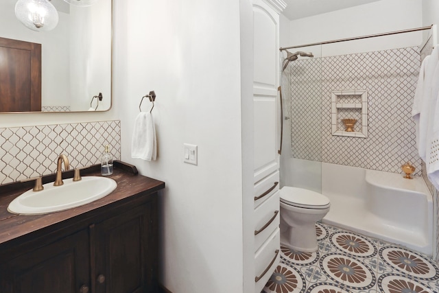 full bathroom with tiled shower / bath, vanity, toilet, and tile patterned floors