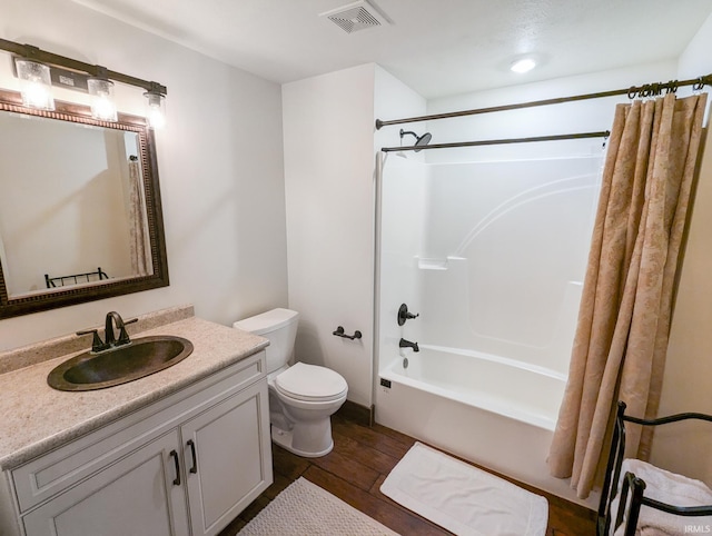 full bathroom with vanity, toilet, wood-type flooring, and shower / tub combo