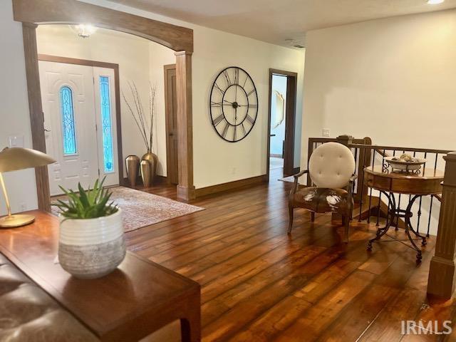 living room featuring hardwood / wood-style floors, a fireplace, and an inviting chandelier