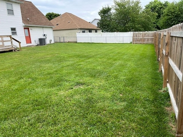 view of yard featuring cooling unit and a wooden deck