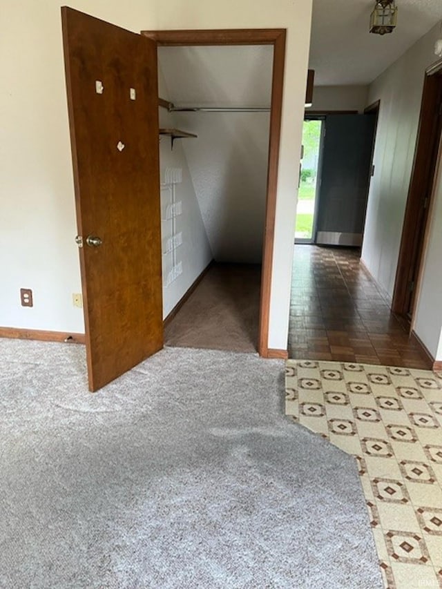 unfurnished bedroom featuring carpet flooring and a closet