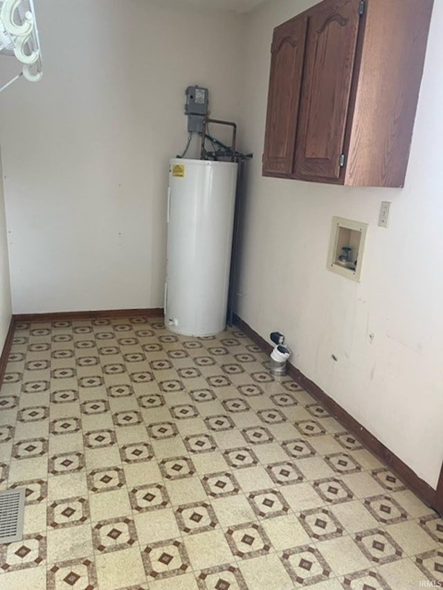 clothes washing area with washer hookup, cabinets, and water heater