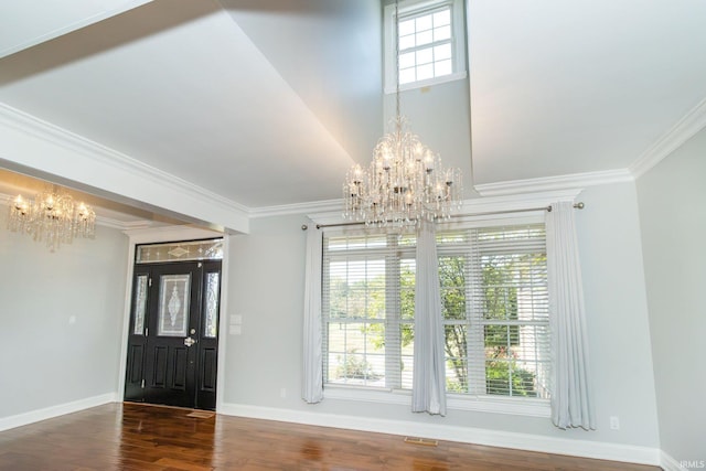 interior space with hardwood / wood-style floors, a wealth of natural light, crown molding, and a notable chandelier