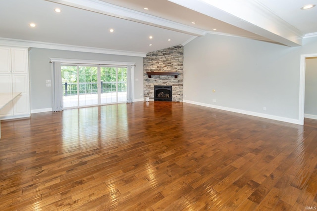 unfurnished living room with lofted ceiling, ornamental molding, dark hardwood / wood-style flooring, and a stone fireplace