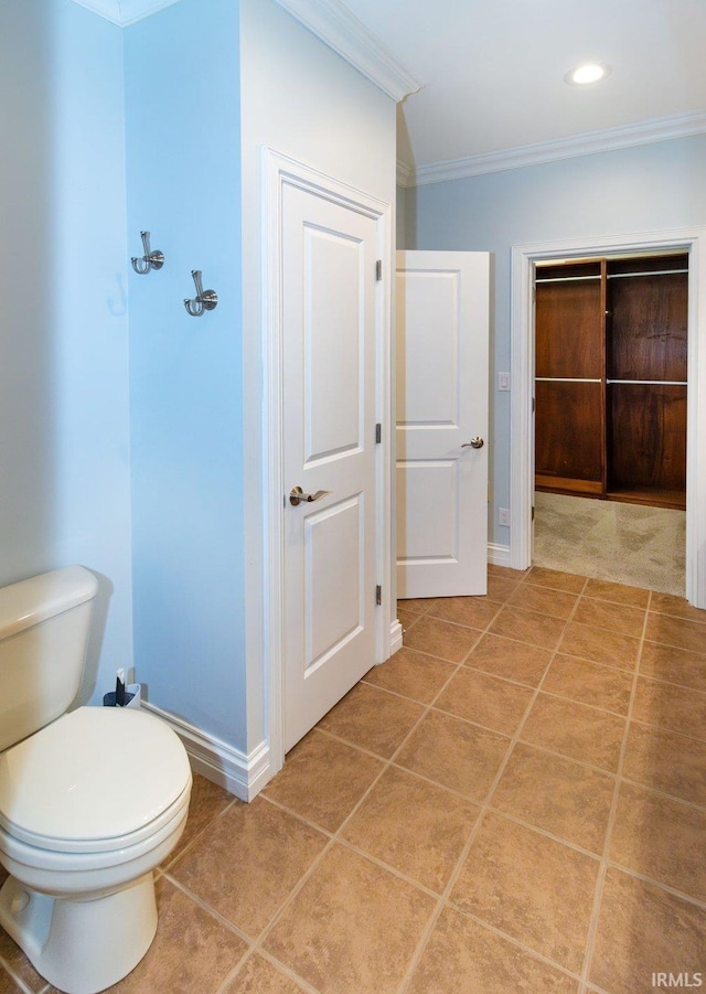 bathroom featuring toilet, ornamental molding, and tile patterned floors