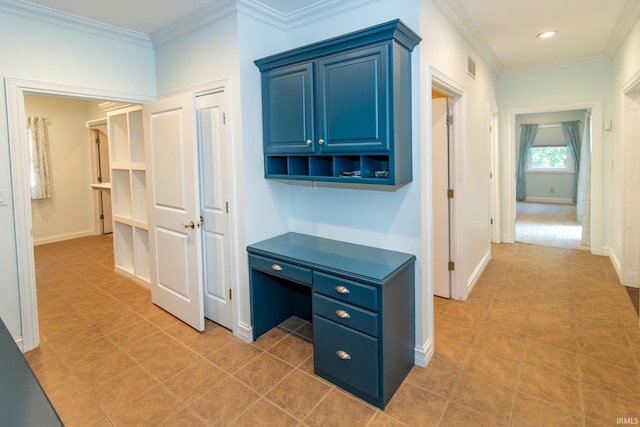 hallway featuring crown molding and light tile patterned floors