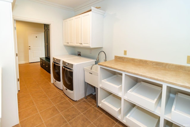 washroom featuring crown molding, cabinets, washing machine and clothes dryer, and tile patterned floors