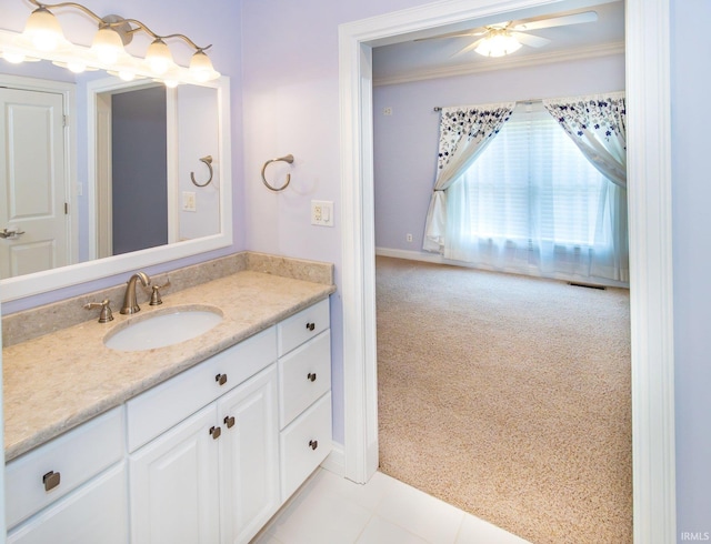 bathroom featuring tile patterned flooring, vanity, ceiling fan, and ornamental molding