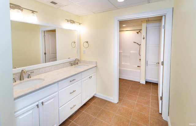 bathroom with tile patterned flooring, vanity, and washtub / shower combination