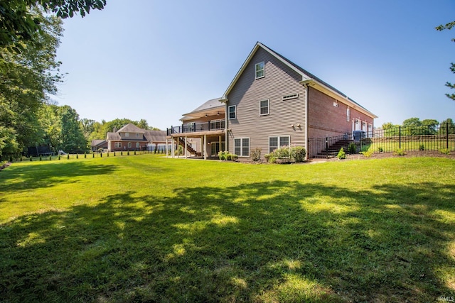 back of house featuring a yard and a wooden deck