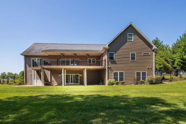 back of house with a balcony, ceiling fan, a yard, and a patio area