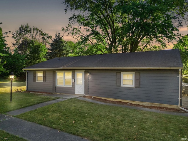 ranch-style house with a yard