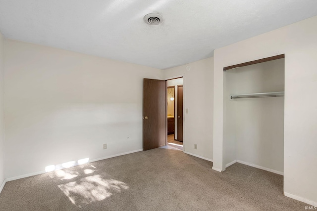 unfurnished bedroom featuring a closet and carpet floors