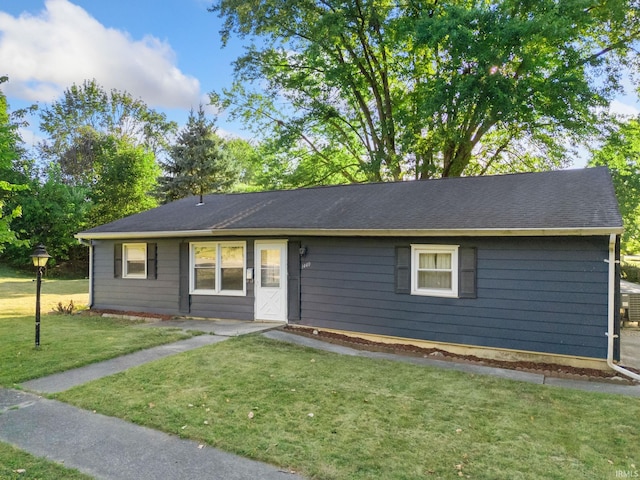 single story home featuring a front lawn