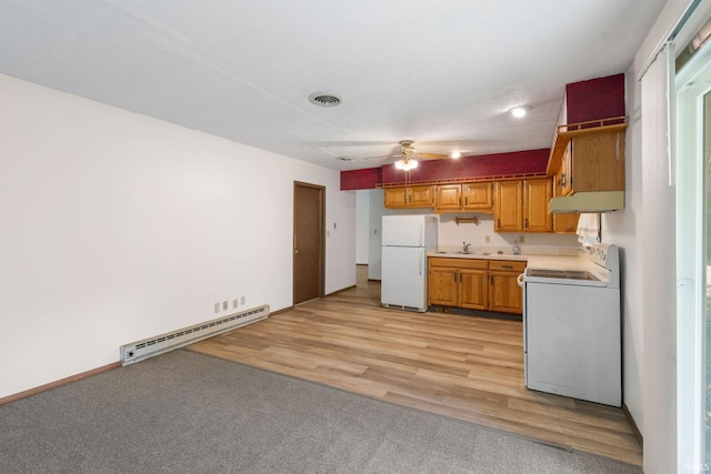 kitchen featuring white appliances, baseboard heating, light hardwood / wood-style floors, sink, and ceiling fan