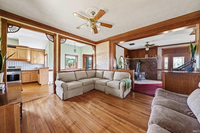 2286 W 500 S Rd, Pleasant Lake, IN 46779 - living room with a wealth of natural light, light wood-style floors, ceiling fan, and a wood stove