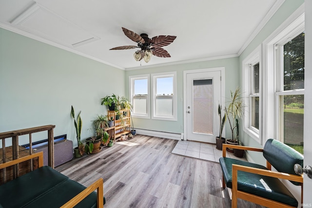 sunroom / solarium featuring a baseboard heating unit and ceiling fan