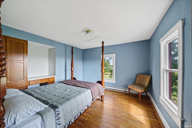 2286 W 500 S Rd, Pleasant Lake, IN 46779 - bedroom with baseboards, light wood-style flooring, and a baseboard heating unit
