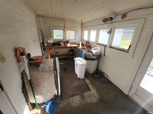 misc room featuring vaulted ceiling and concrete flooring