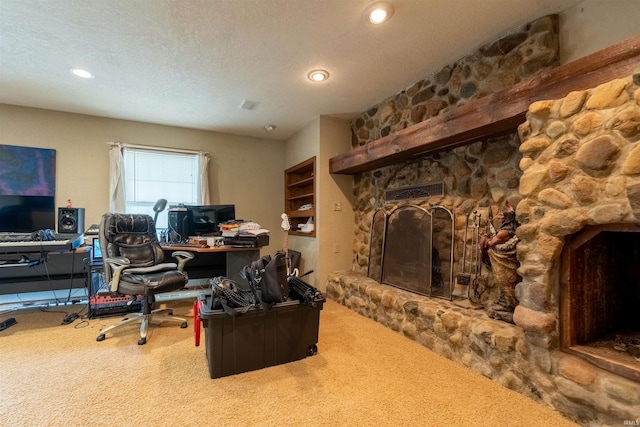 carpeted home office featuring a textured ceiling and a fireplace